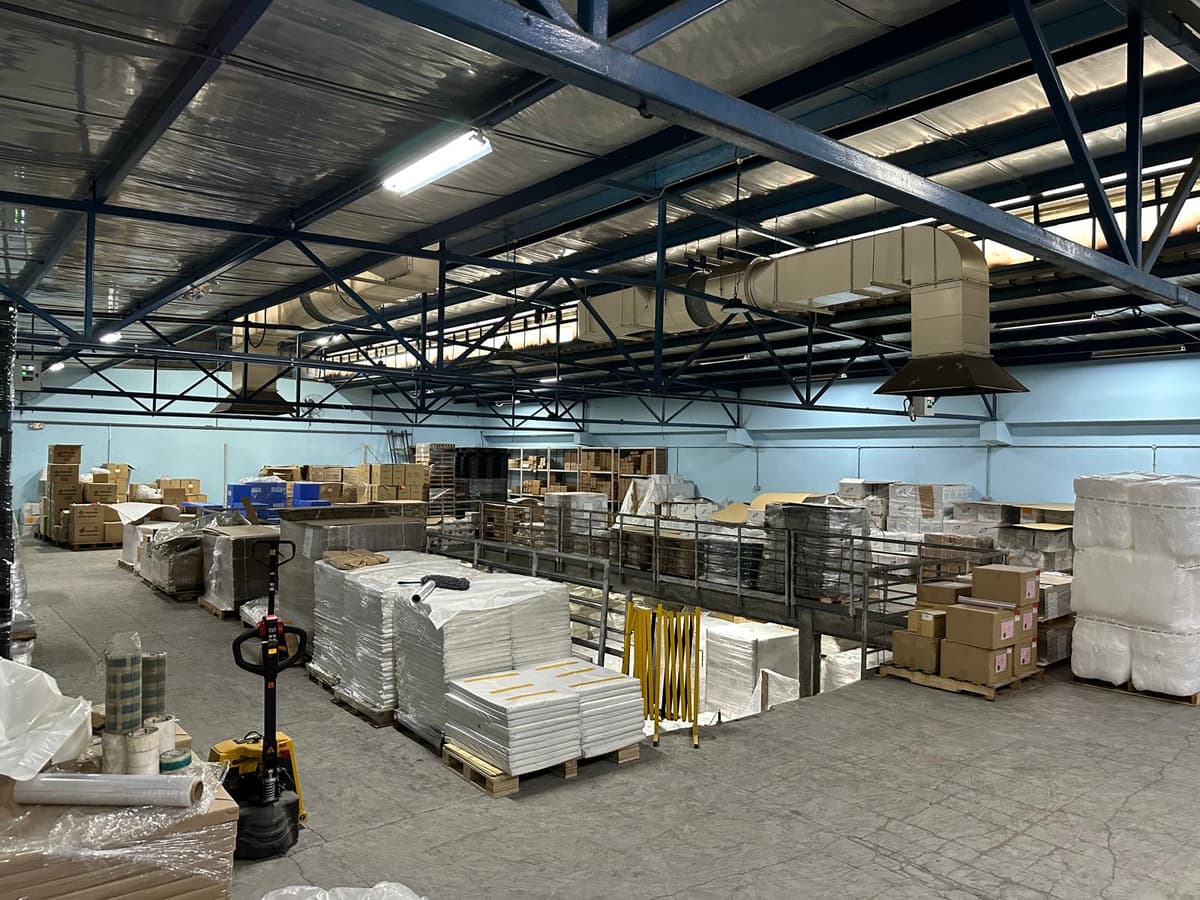 Megapac Industries warehouse overview with palletised stock and mezzanine